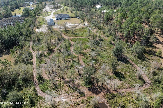 bird's eye view featuring a wooded view