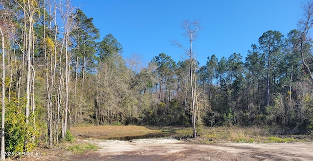 view of landscape featuring a wooded view