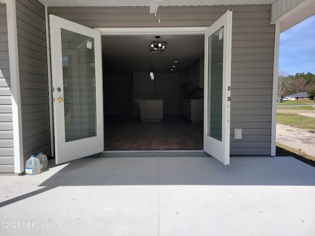 view of exterior entry featuring a patio area
