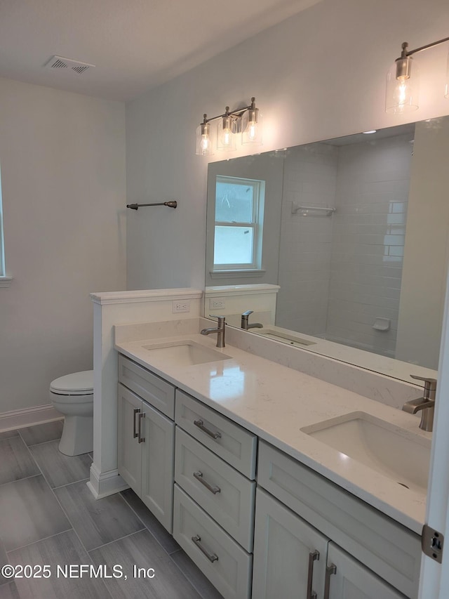 bathroom featuring double vanity and a sink