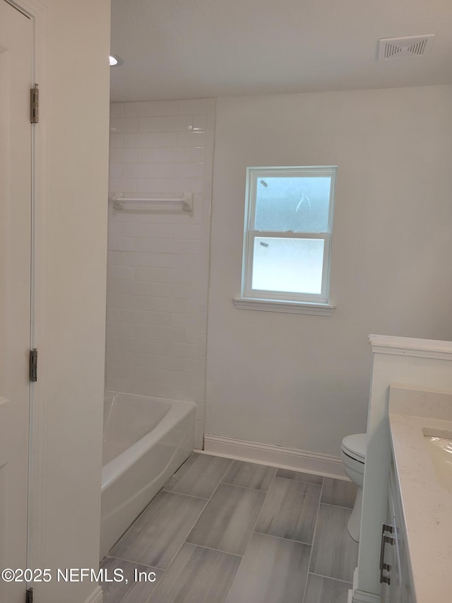full bath with visible vents, baseboards, toilet, and vanity