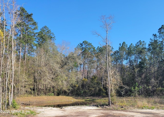 view of road featuring a wooded view