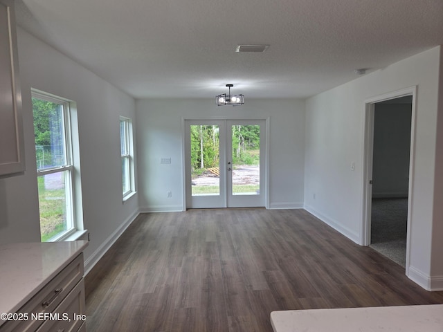 54356 Jamie Dr, Callahan, FL 32011 - unfurnished dining area featuring dark wood-style floors, a chandelier, healthy amount of natural light, and baseboards