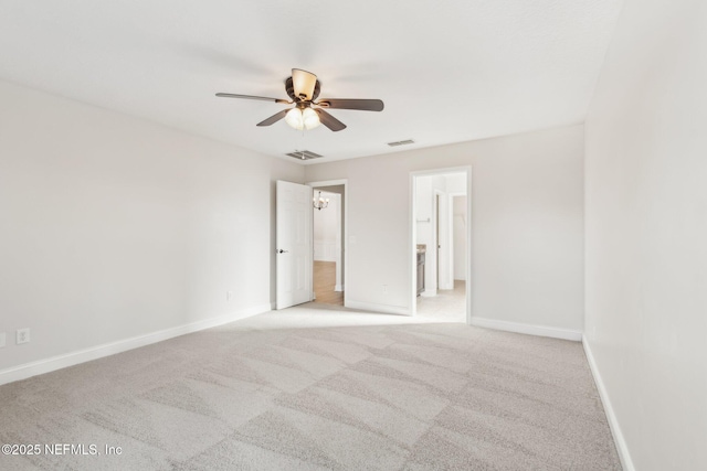 unfurnished room with visible vents, ceiling fan, light carpet, and baseboards