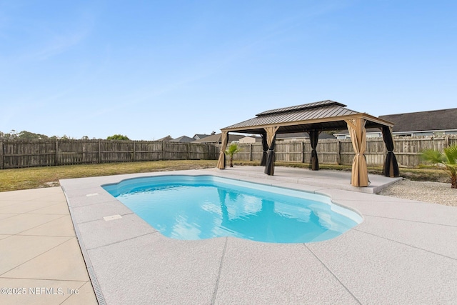 view of pool with a fenced backyard, a fenced in pool, a patio, and a gazebo