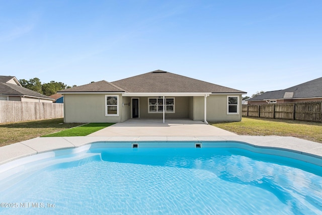 view of pool featuring a yard, a patio area, a fenced backyard, and a fenced in pool