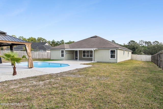 view of pool featuring a fenced backyard, a gazebo, a yard, a fenced in pool, and a patio area