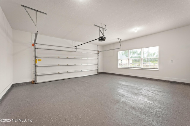 garage featuring baseboards and a garage door opener