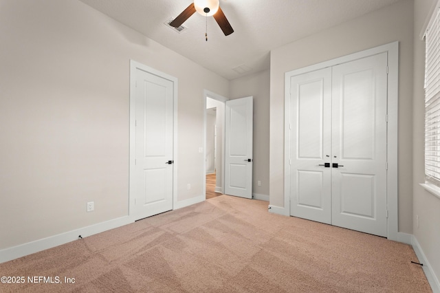 unfurnished bedroom featuring a ceiling fan, carpet, visible vents, and baseboards