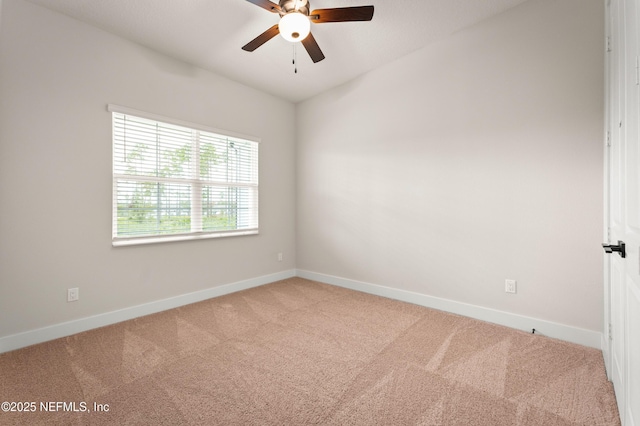 empty room featuring carpet floors, baseboards, and a ceiling fan