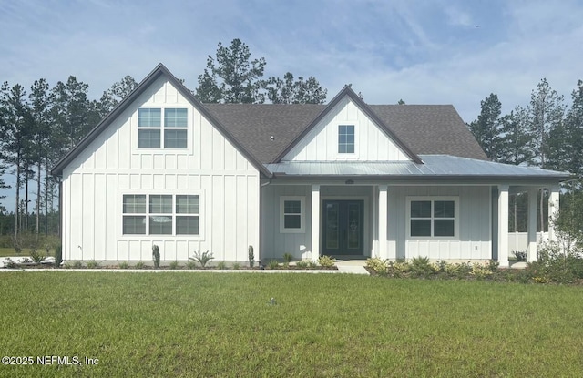 36263 Pitch Ln, Hilliard, FL 32046 - modern inspired farmhouse featuring board and batten siding, a front yard, french doors, and a shingled roof