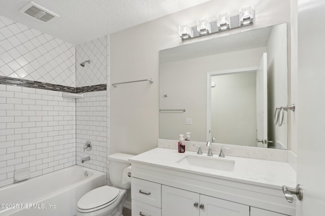 bathroom with visible vents, toilet, shower / bath combination, vanity, and a textured ceiling