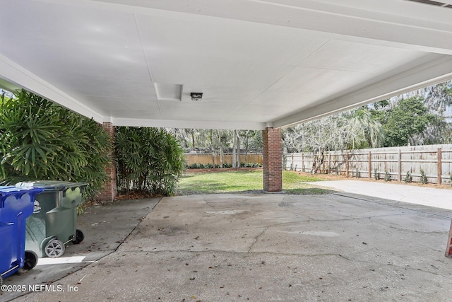 view of patio / terrace featuring an attached carport and a fenced backyard
