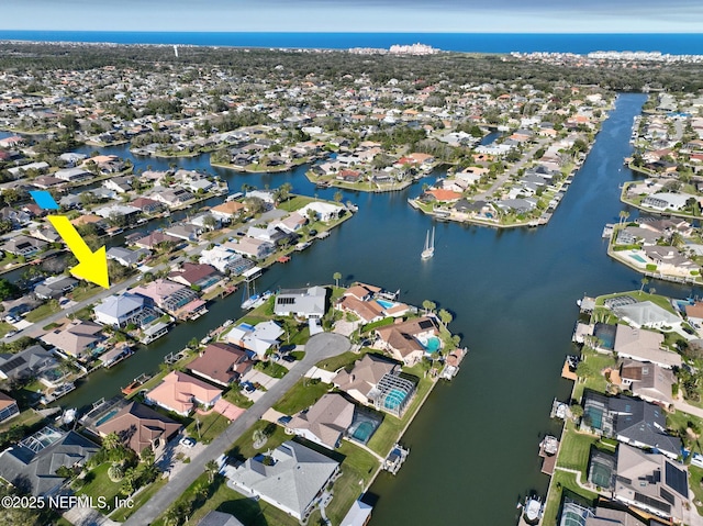 drone / aerial view featuring a water view and a residential view