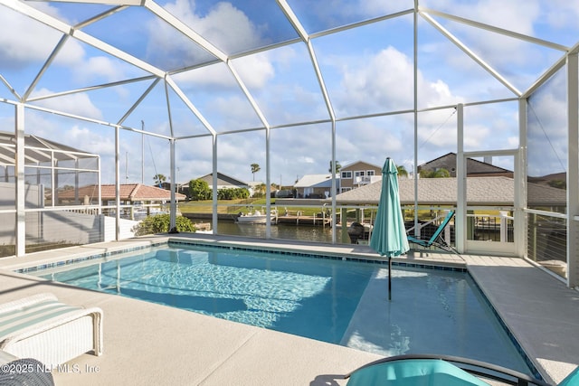 outdoor pool with a patio area, a lanai, and a water view