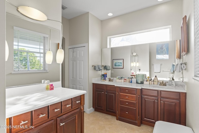 full bathroom featuring tile patterned flooring, visible vents, a sink, and double vanity