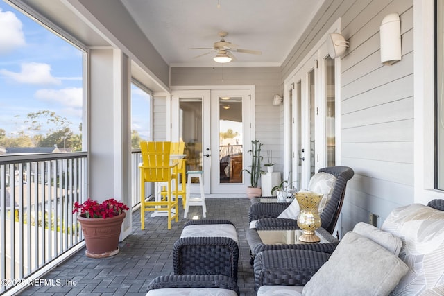 sunroom with a ceiling fan and french doors