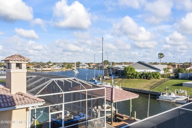 dock area with a water view and glass enclosure