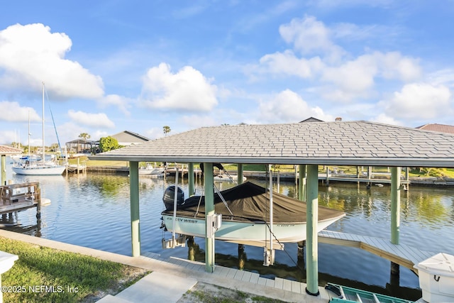 dock area with a water view and boat lift