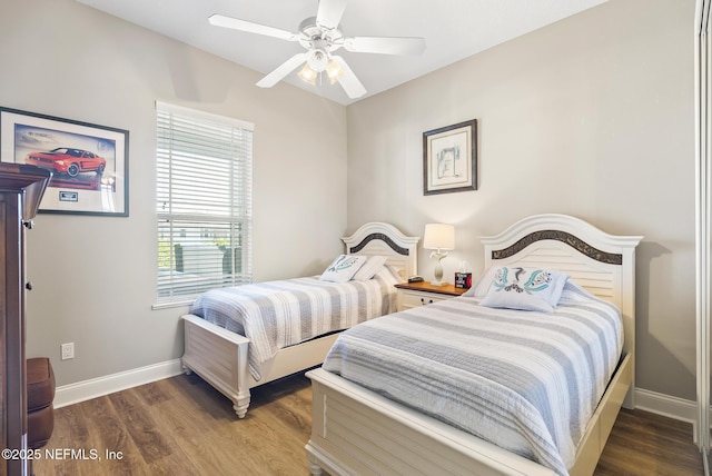 bedroom with a ceiling fan, baseboards, and wood finished floors