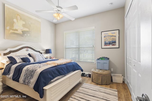 bedroom with baseboards, a ceiling fan, a closet, and wood finished floors