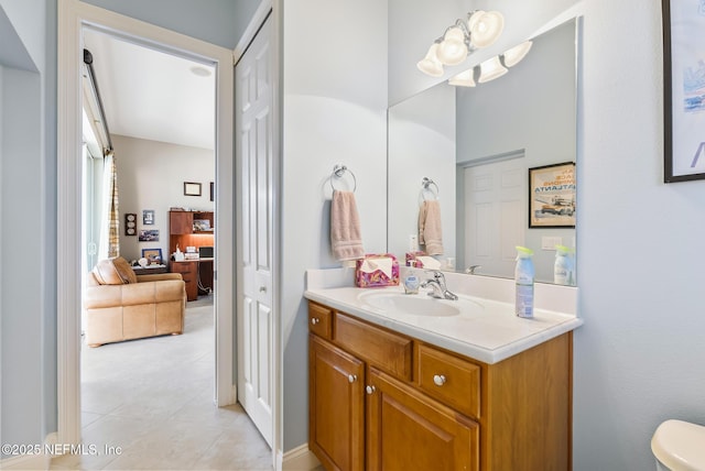 bathroom featuring toilet, tile patterned flooring, and vanity