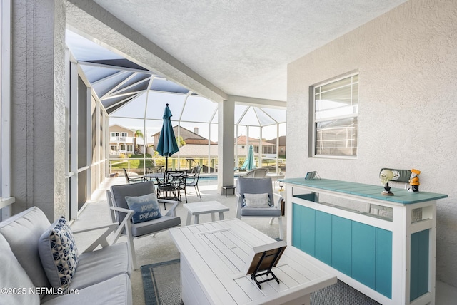 view of patio / terrace featuring a lanai and outdoor dining space
