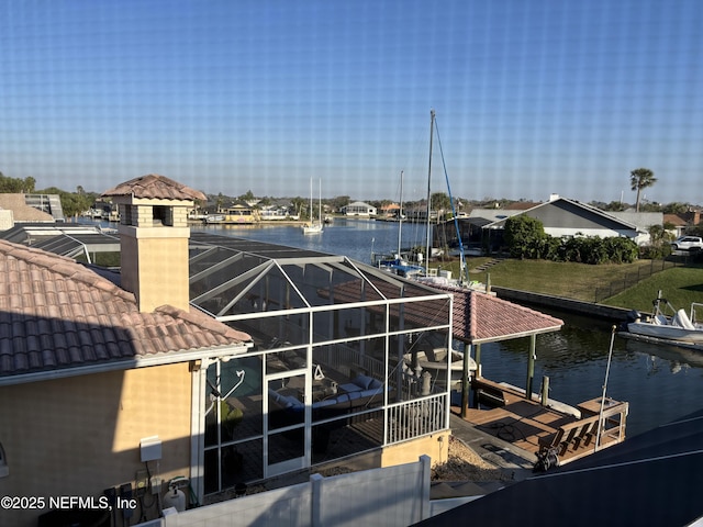 dock area featuring a lanai and a water view