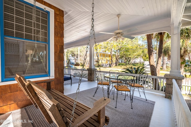 wooden deck with covered porch and ceiling fan