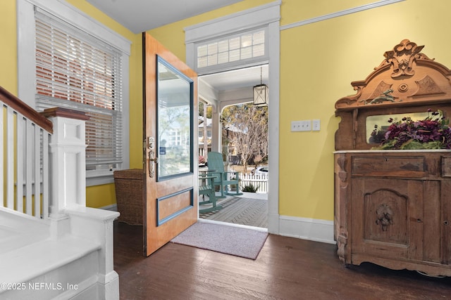 foyer entrance featuring baseboards, stairway, and dark wood-style flooring