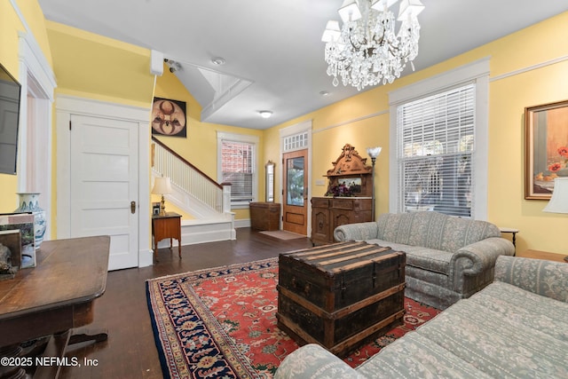 living area featuring a chandelier, stairway, and wood finished floors