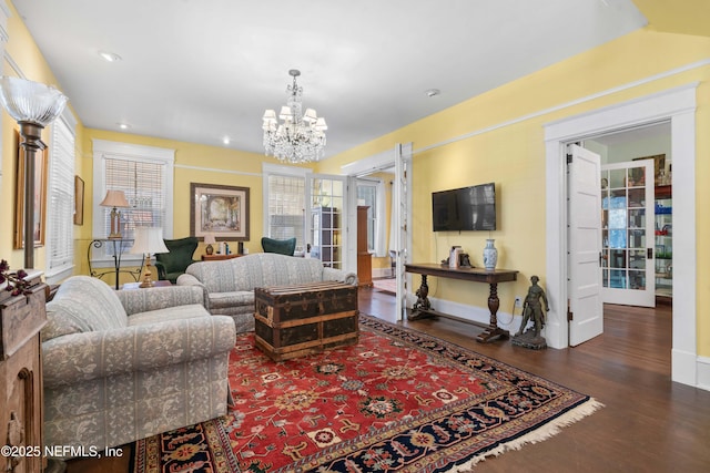 living room with baseboards, recessed lighting, wood finished floors, and a notable chandelier