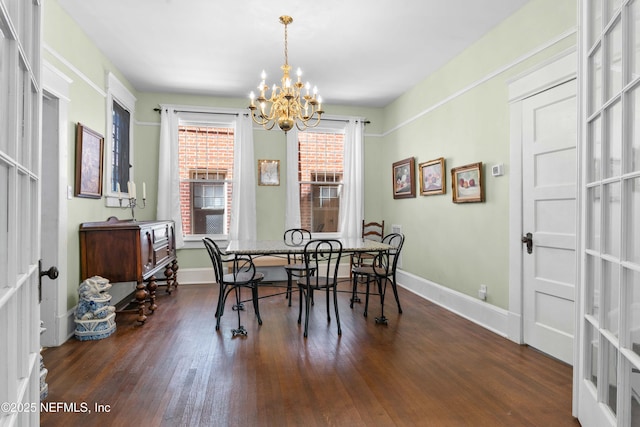 dining area featuring a notable chandelier, baseboards, and dark wood-style flooring