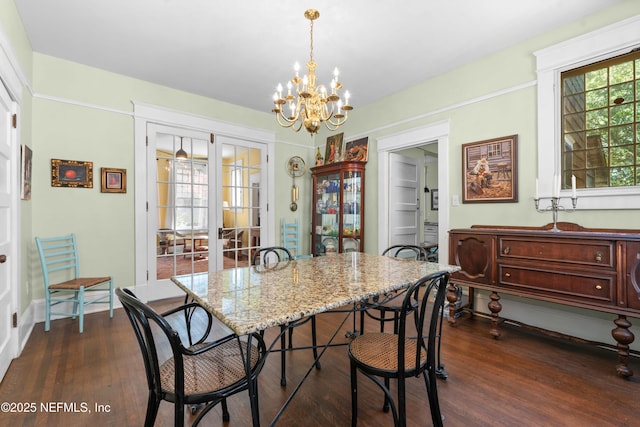 dining area with a notable chandelier, baseboards, dark wood-style flooring, and french doors