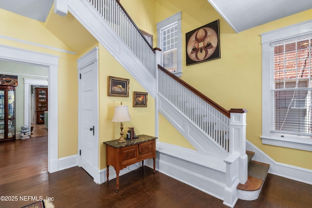 stairway featuring wood finished floors and baseboards