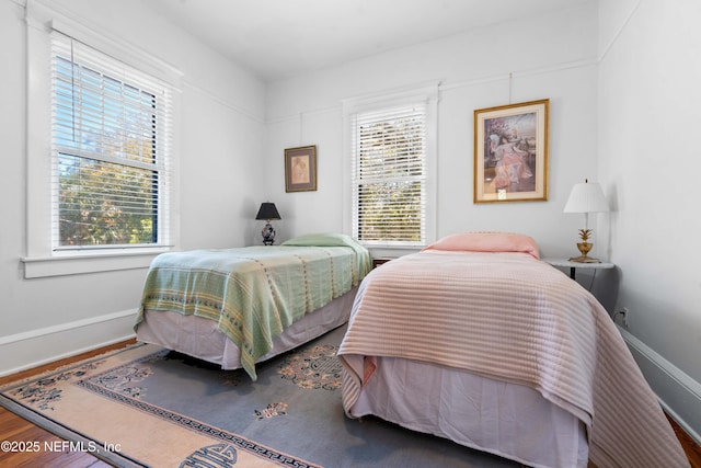 bedroom with wood finished floors and baseboards