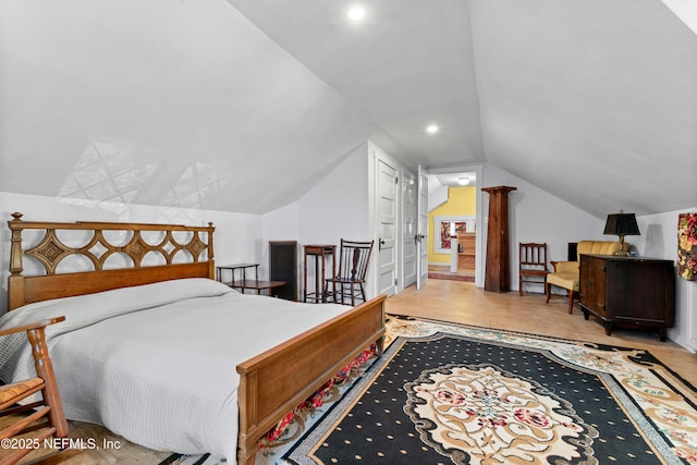 bedroom featuring vaulted ceiling, wood finished floors, decorative columns, and recessed lighting