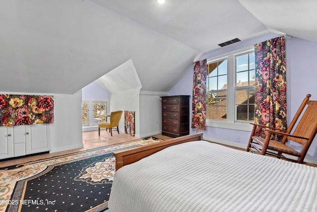 bedroom with baseboards, multiple windows, visible vents, and vaulted ceiling