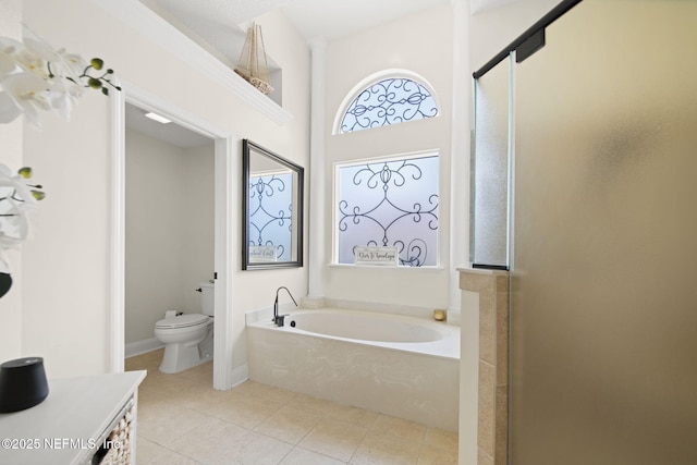 bathroom with a garden tub, a shower stall, toilet, and tile patterned floors