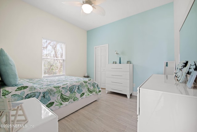 bedroom with ceiling fan and baseboards