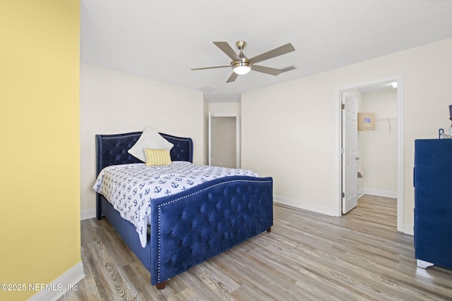 bedroom with visible vents, baseboards, ceiling fan, and wood finished floors