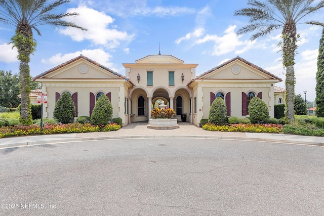 view of front of home with stucco siding and a tile roof