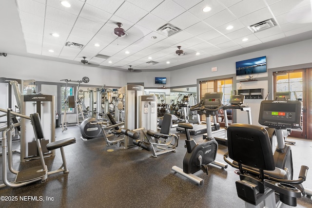 gym with a paneled ceiling and visible vents