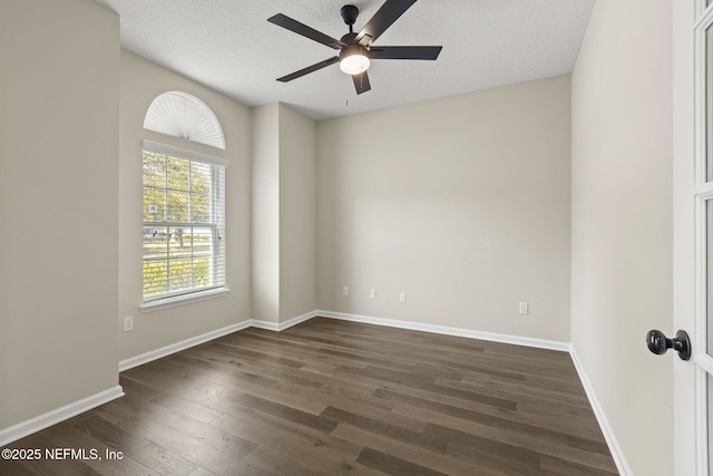 empty room featuring dark wood-style floors, a textured ceiling, baseboards, and a ceiling fan