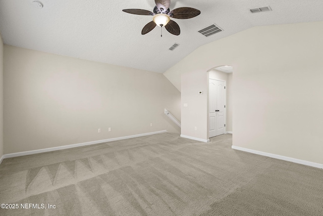 unfurnished room featuring vaulted ceiling, baseboards, and visible vents