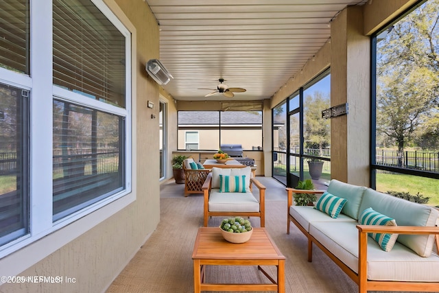 sunroom with a ceiling fan