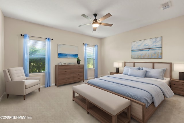 bedroom featuring ceiling fan, baseboards, and light carpet