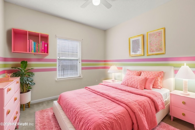 carpeted bedroom with baseboards and a ceiling fan