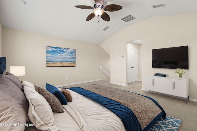 bedroom featuring visible vents, light colored carpet, and vaulted ceiling