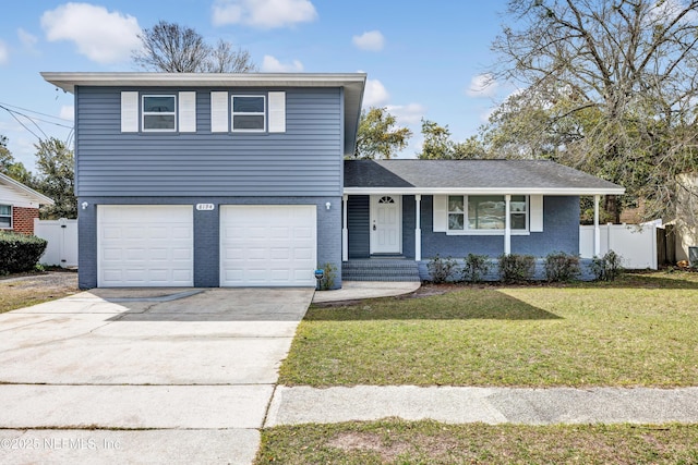 view of front of house with brick siding, concrete driveway, fence, a garage, and a front lawn